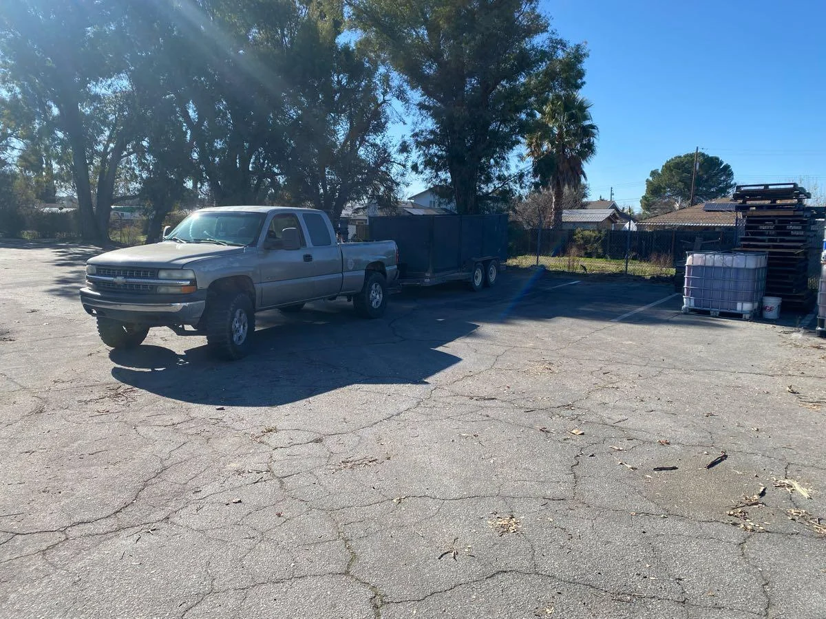 Pickup truck and dump trailer on a driveway